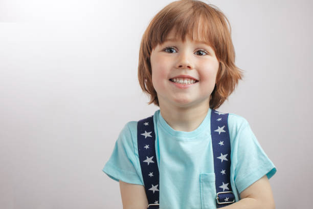 istock red-haired nice boy with beautiful sparkling brown eyes 1131998271