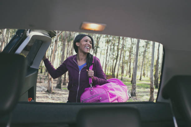 istock Woman unpacking car trunk. 1131999225