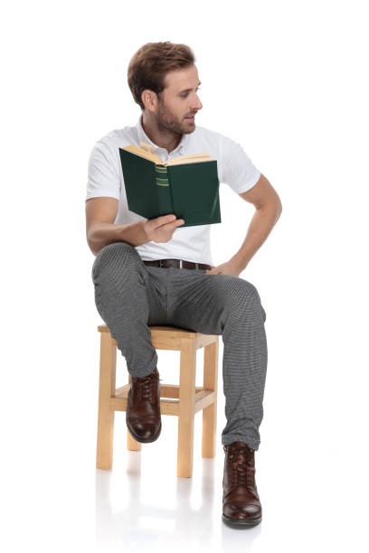 istock man sitting holds a book and looks to side 1132000032