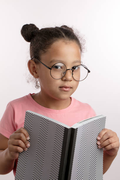 istock serious smart shcool girl doing her homework 1132000051