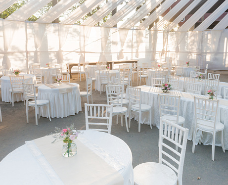 An outdoor venue for a white wedding, on a bright sunny day