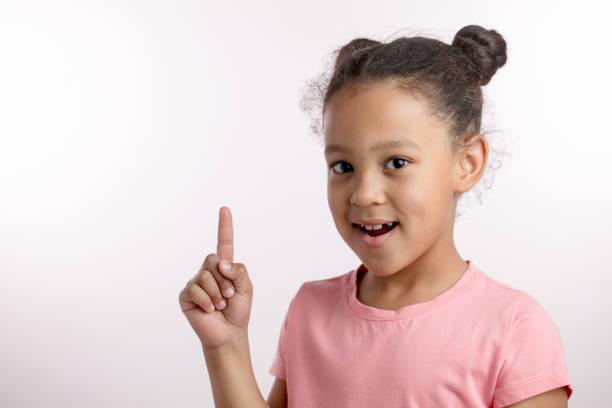 istock clever girl raising her finger up 1132000135