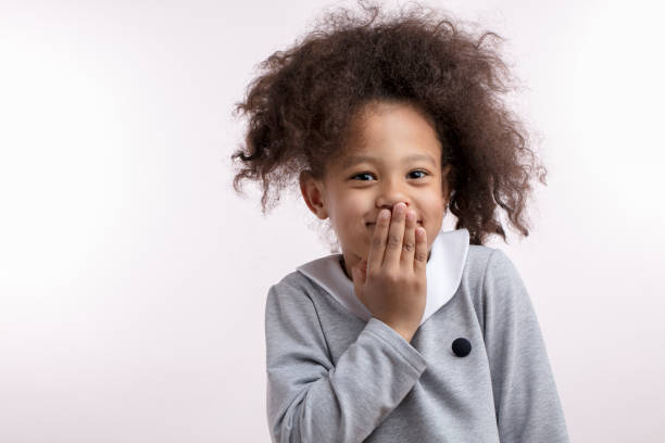 istock giggling afro child with funny ponitail looking at the camera 1132000229