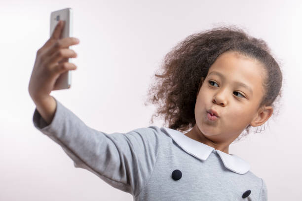 istock funny African girl is taking a selfie 1132000313
