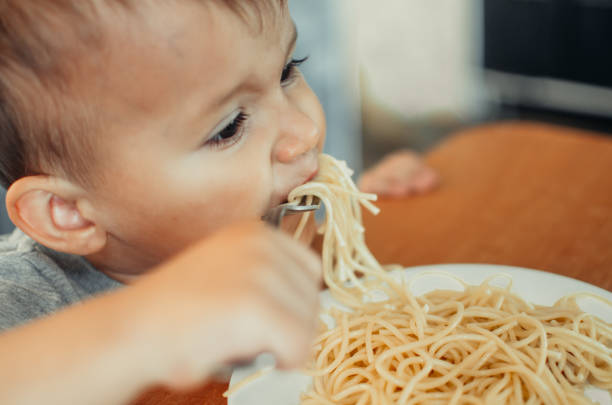 istock Little boy with mom in the kitchen preparing dough 1132000764