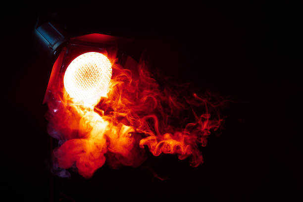 istock Red light with smoke in the dark. Equipment for photo Studio. 1132000816