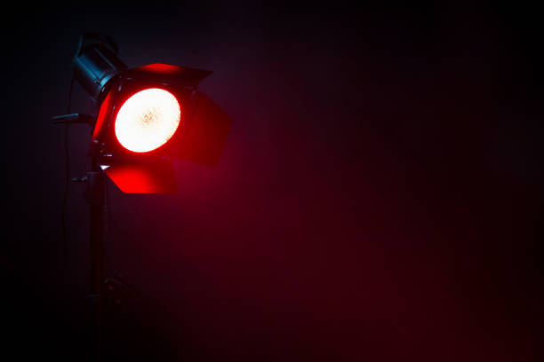 istock Red light with smoke in the dark. Equipment for photo Studio. 1132000817