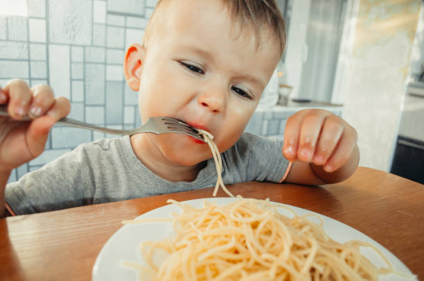 istock Little boy with mom in the kitchen preparing dough 1132000833