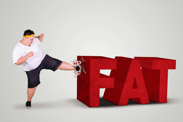 istock Angry fat man kicking fat word on studio 1132000835