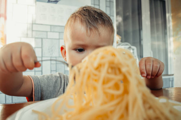 istock Little boy with mom in the kitchen preparing dough 1132002411
