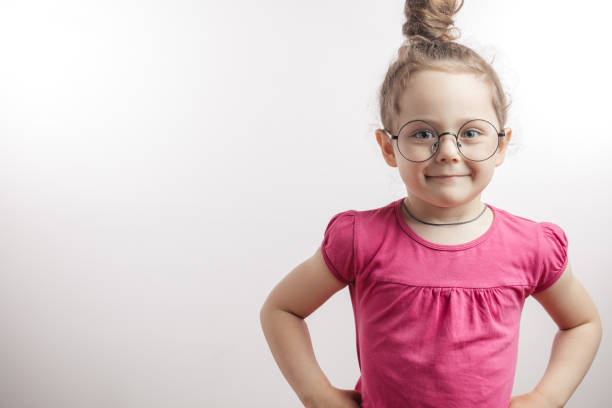 istock clever kid with hairbun posing to the camera 1132002467