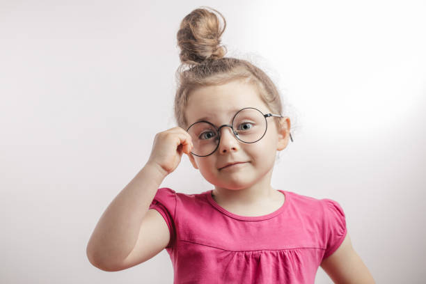 istock child prodigy concept. gifted cute kid looking through the round glasses 1132002477