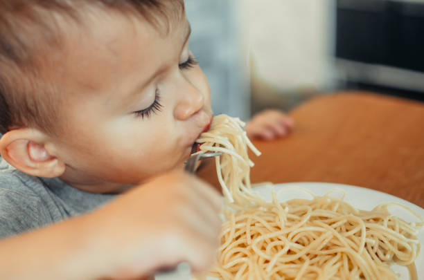 istock Little boy with mom in the kitchen preparing dough 1132002526