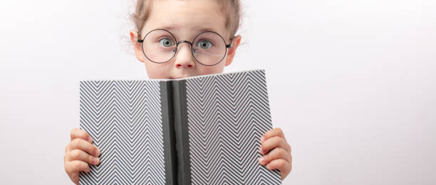 istock fearful girl is covering her face with a book 1132003082