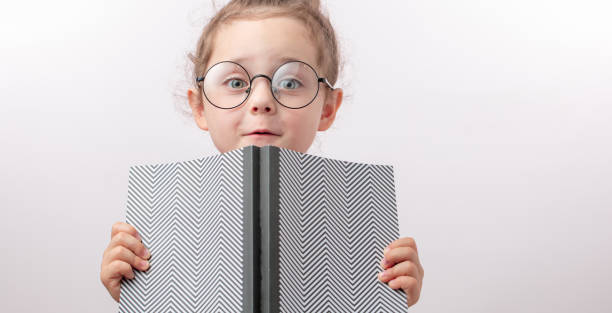 istock little bookworm in round glasses is looking at the camera 1132003093