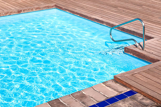 istock Wooden floor beside the blue swimming pool 113200342