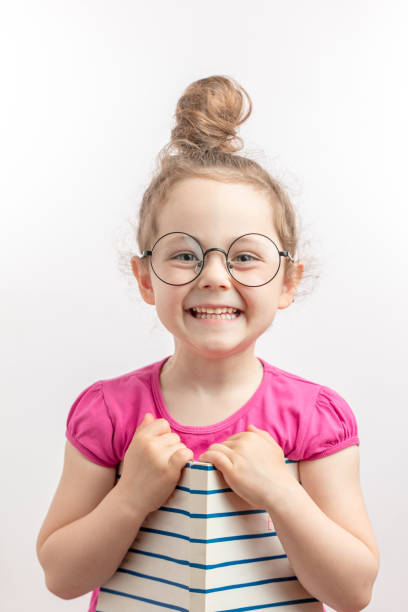 istock smiling ginger girl is having fun with a book 1132003721
