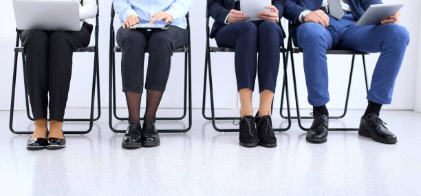 istock Group of business people sitting in office and waiting for job interview while using gadgets, close-up. Conference or training concepts 1132004112