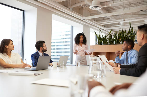 istock Businesswoman Standing Giving Presentation To Colleagues In Modern Open Plan Office 1132005708