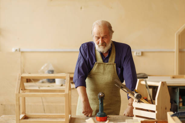 istock pensive old master is resting after making the basic of dollhouse 1132005834