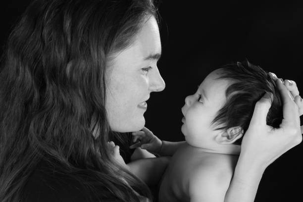 istock Side view of a smiling mother looking at her infant son 1132005870