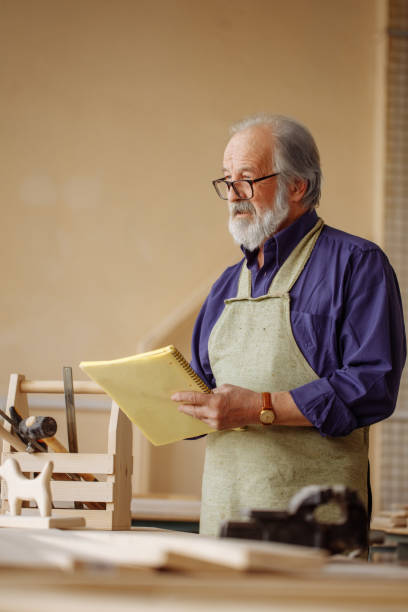 istock old shop teacher holding the register is doing a roll call 1132006069