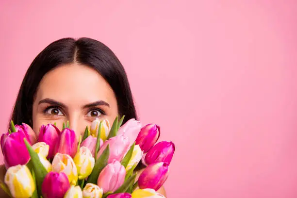 Close-up cropped portrait of her she nice cute attractive lovely winsome charming cheerful cheery brunette latin lady hiding behind colorful flowers florist advert isolated on pink pastel background.