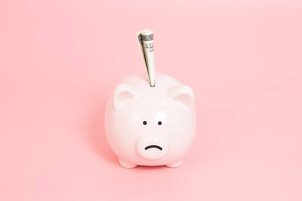 istock Piggy bank money on blue background 1132006285