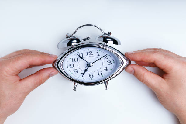 istock A businessman trying to turn back time by pulling on a clock. 1132007400