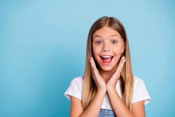 Photo of Close-up profile side portrait of her she nice cute lovely attractive cheerful amazed glad funny straight-haired blonde girl opened mouth gift present wish isolated on blue pastel background