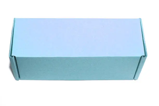 Photo of Cardboard box of blue color. Cardboard box of one tone. Is on a white background.