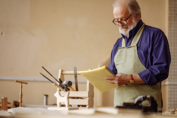 istock attractive retiree in casual clothes and apron is making a draft. 1132007978