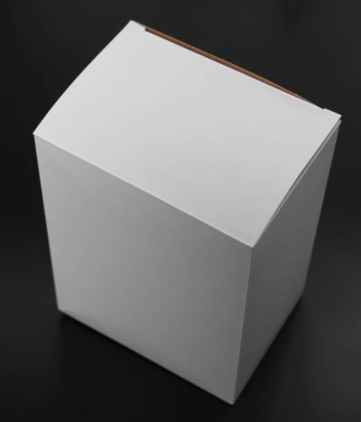 istock White cardboard box on a black background. The box is square in shape. 1132008098