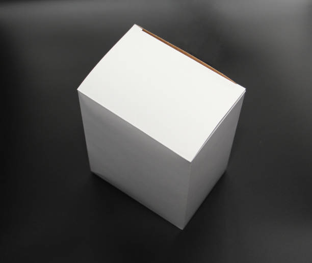istock White cardboard box on a black background. The box is square in shape. 1132008134