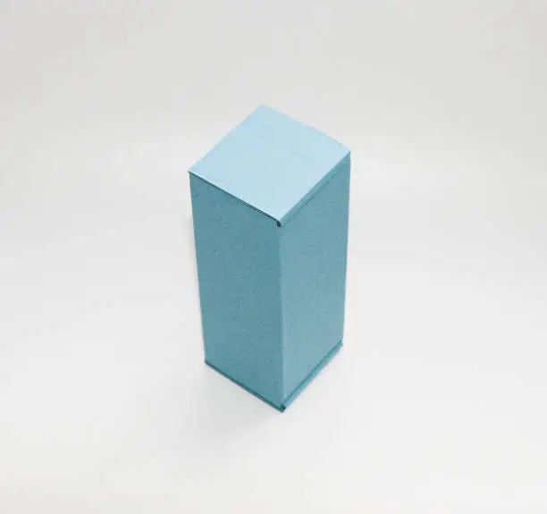 Photo of Cardboard box of blue color. Cardboard box of one tone. Is on a white background.