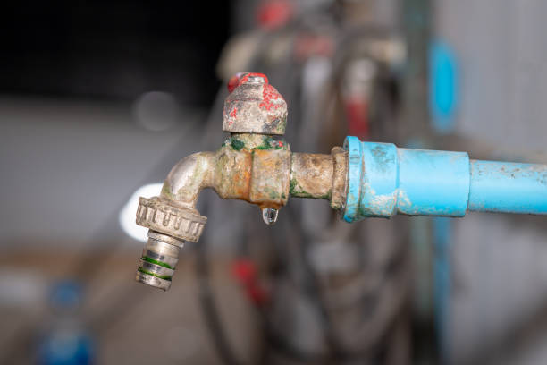 istock The old rusty faucet with water leaking 1132008326