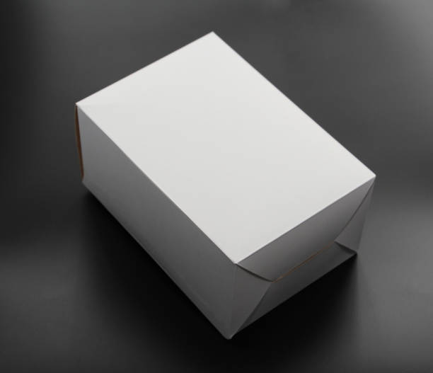 istock White cardboard box on a black background. The box is square in shape. 1132008355