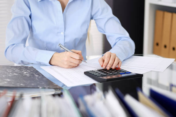 istock Unknown bookkeeper woman or financial inspector  making report, calculating or checking balance, close-up. Business portrait. Audit or tax concepts 1132008479