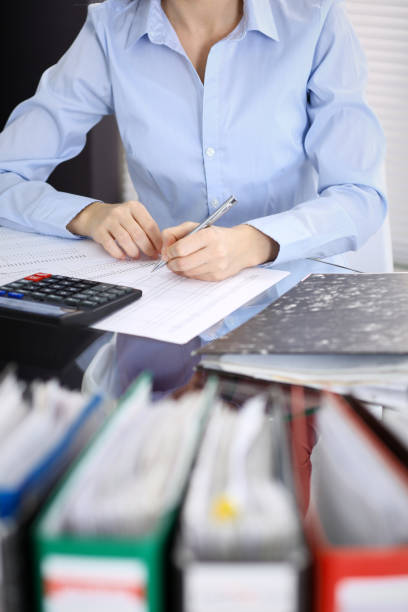 istock Unknown bookkeeper woman or financial inspector  making report, calculating or checking balance, close-up. Business portrait. Audit or tax concepts 1132008487
