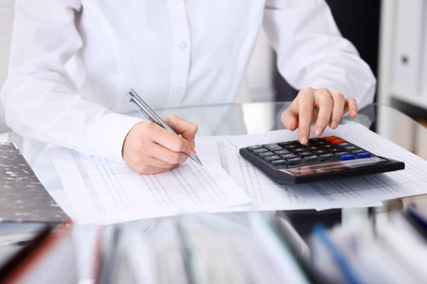 istock Unknown bookkeeper woman or financial inspector  making report, calculating or checking balance, close-up. Business portrait. Audit or tax concepts 1132008497