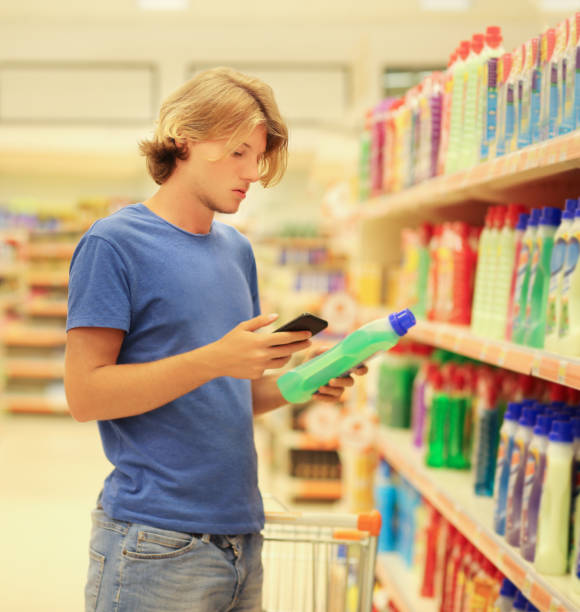 istock Man shopping in supermarket reading product information 1132009241