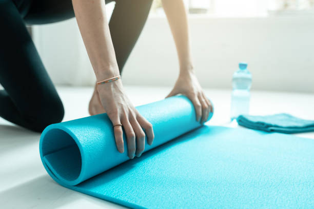 istock Young woman rolling her mat after exercising, hands close up 1132009916