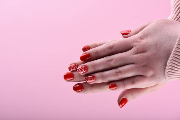 istock Hands of a girl with a red manicure on her nails 1132010202