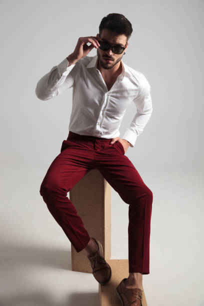 istock attractive man wearing unbuttoned shirt fixes his glasses 1132010381