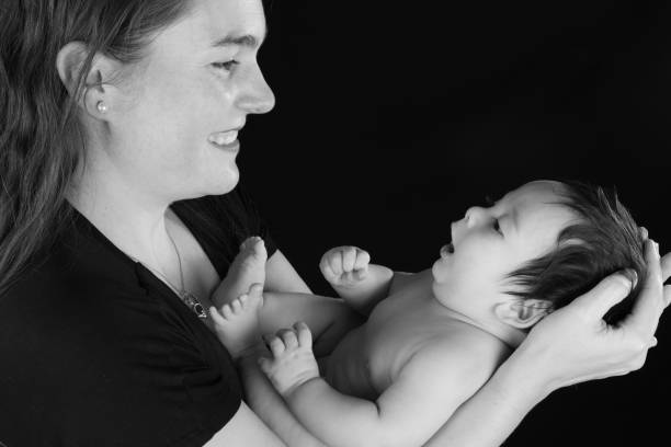 istock Side view of a smiling mother looking at her infant son 1132010581