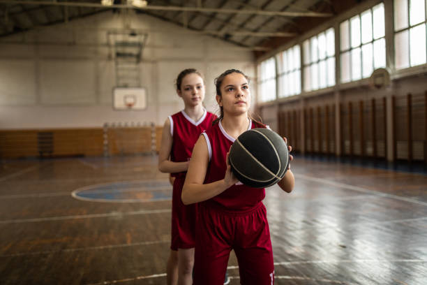 istock Teenage girls practicing free throws 1132010640