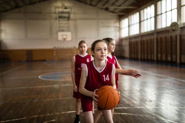 istock Teenage girls practicing free throws 1132010647