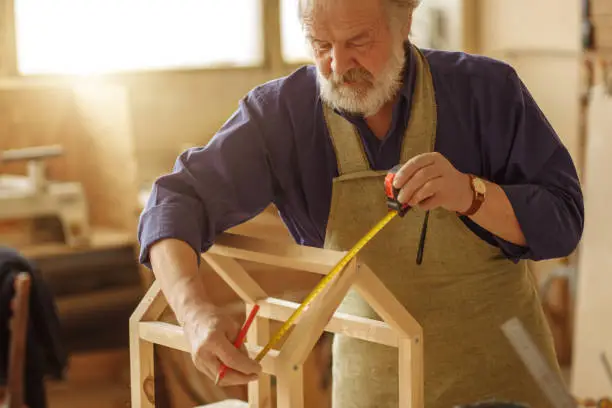 Photo of detailed process of creating wooden feeder