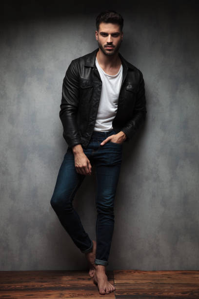 istock relaxed sexy young man in leather jacket and bare feet 1132010983