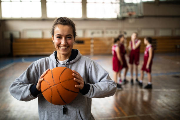 istock Attractive female basketball coach holding ball 1132012251